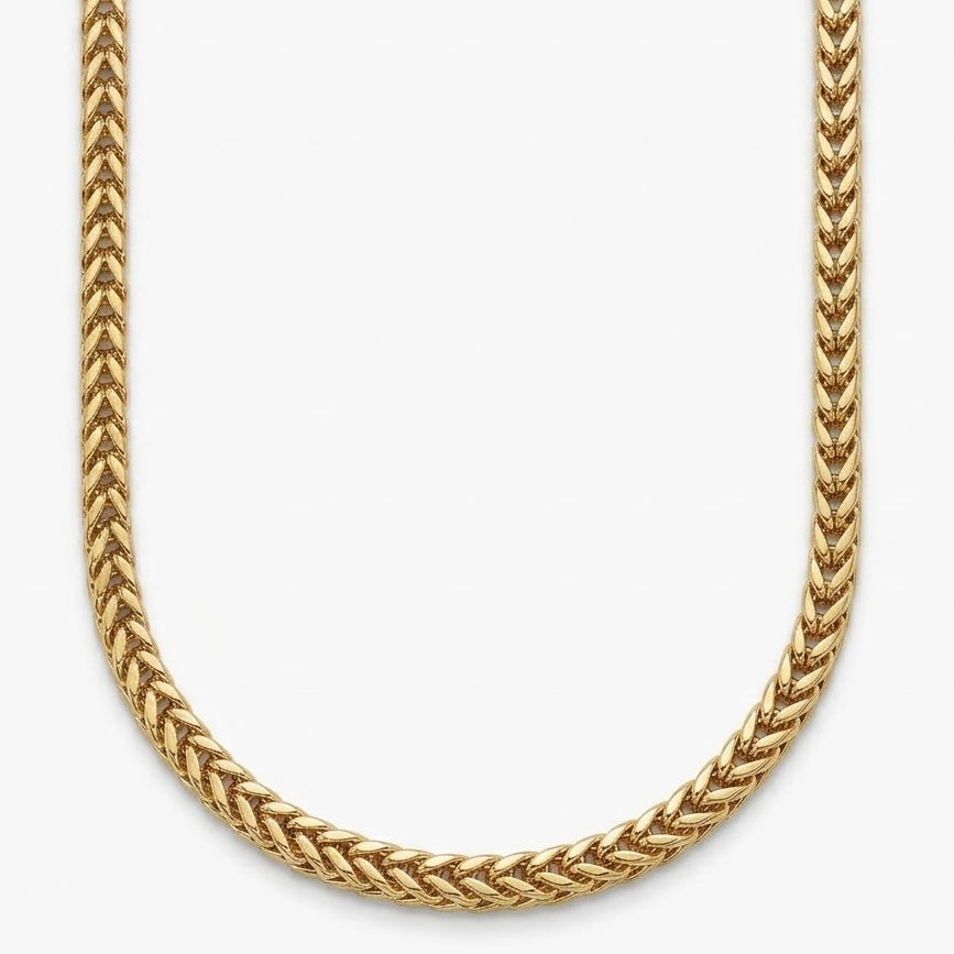 Close up of a 14k gold Franco chain on a white background in a u shape 