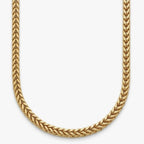 Close up of a 14k gold Franco chain on a white background in a u shape 