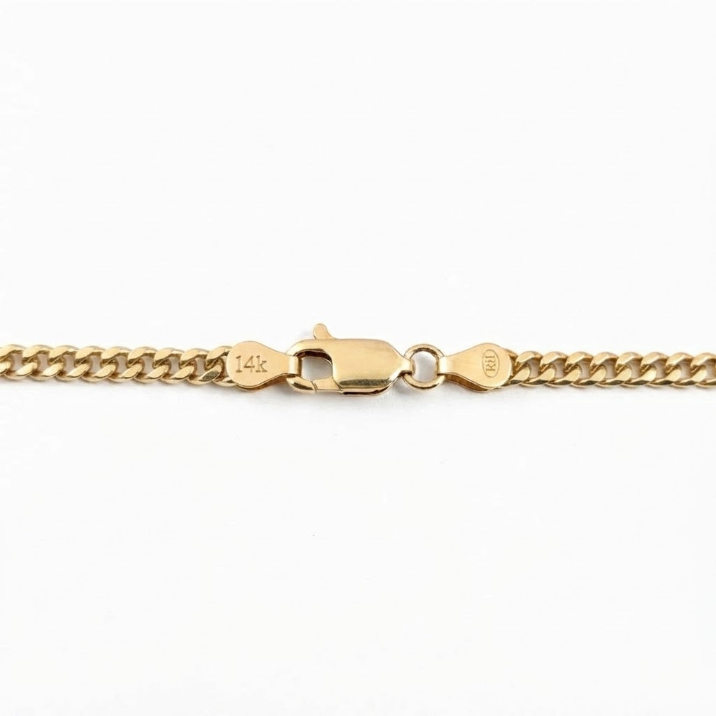 Close-up of a gold chain bracelet showing a lobster clasp with '14K' hallmarks on a plain white background.