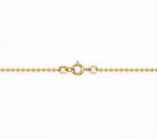 A close-up of a gold ball chain necklace showing the lobster clasp and a small circular brand engraving on a plain white background.